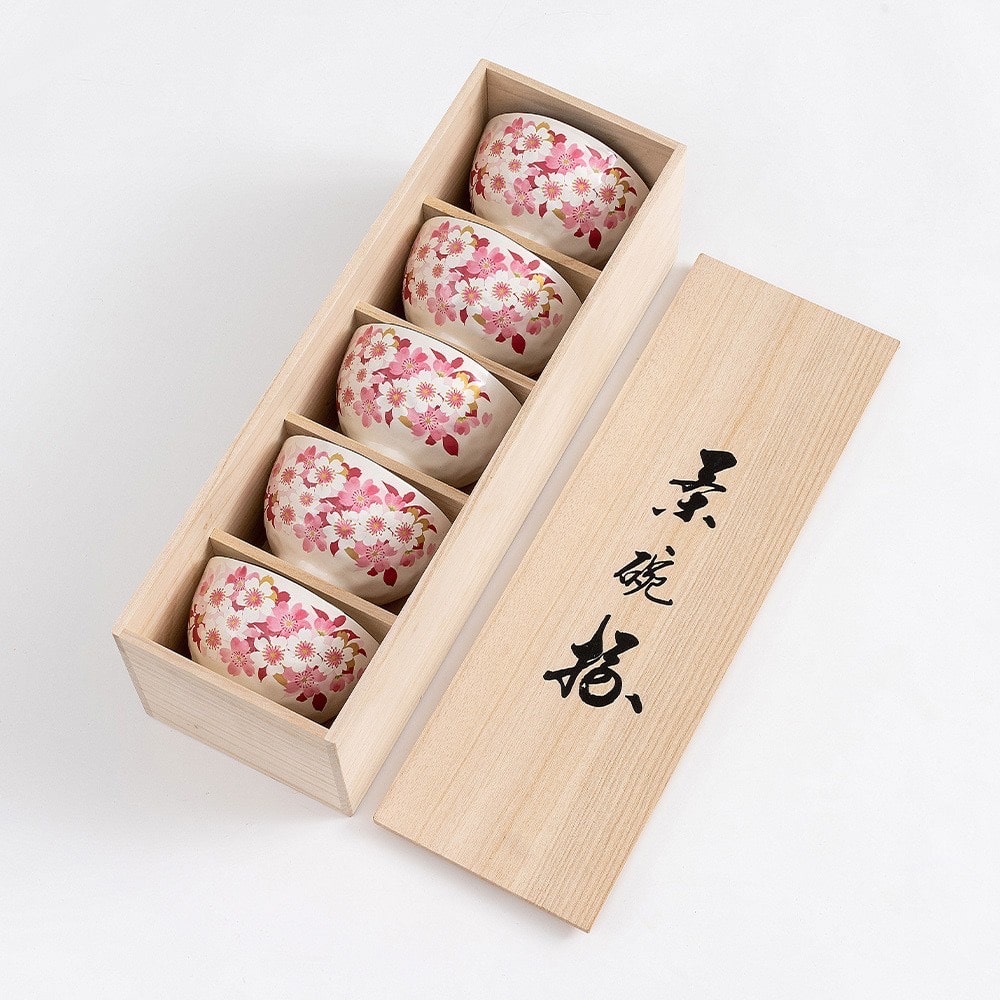 Close-up of vibrant floral designs on ceramic rice bowls.