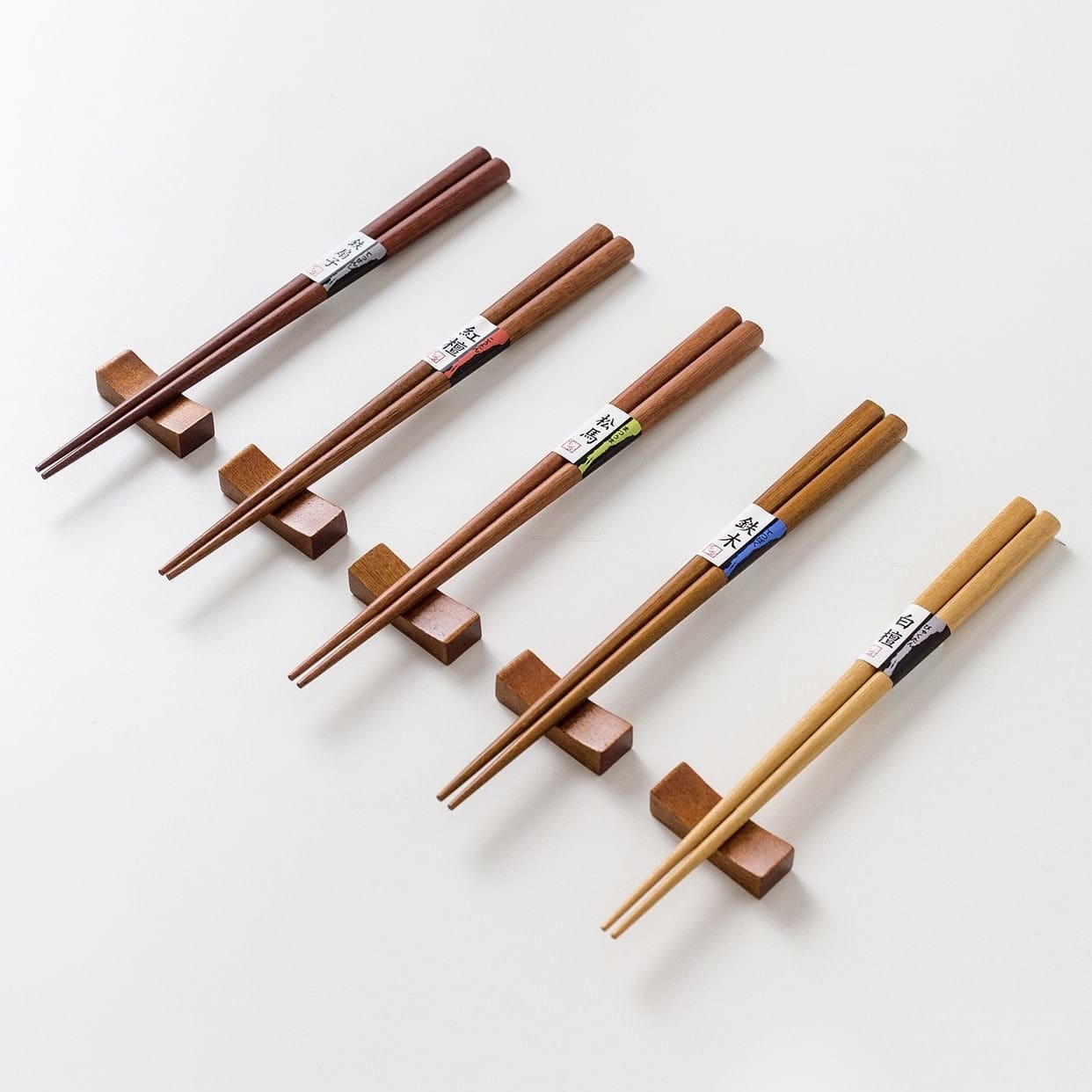 Five pairs of wooden chopsticks arranged in a set.