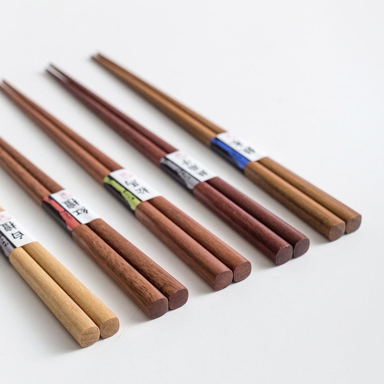 Close-up of premium wooden Japanese chopsticks with labels.