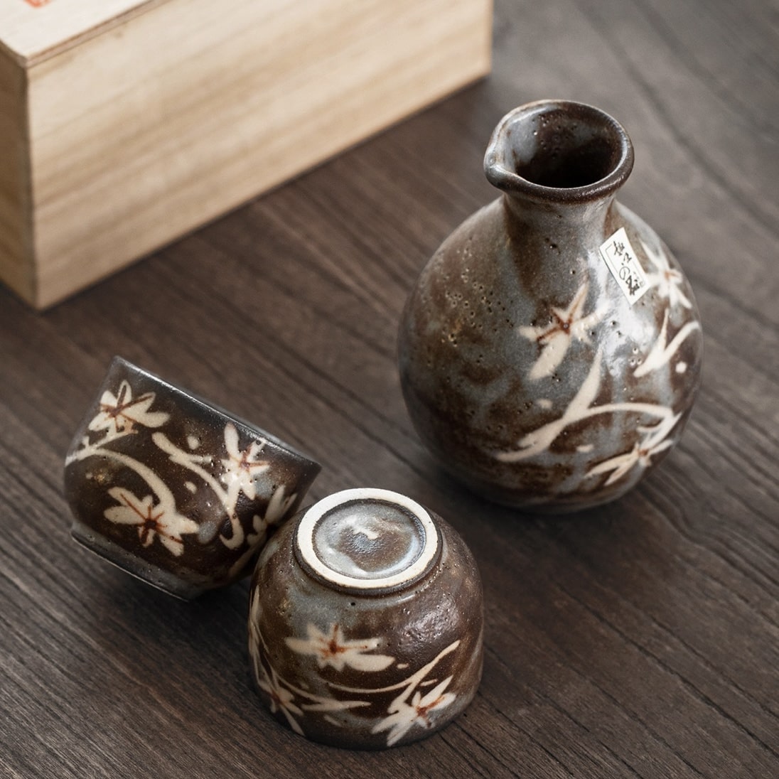 Close-up of a Tokkuri sake bottle being poured into a ceramic cup