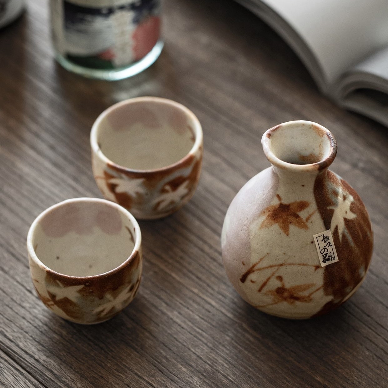 Rustic Japanese ceramic sake set displayed in a wooden gift box