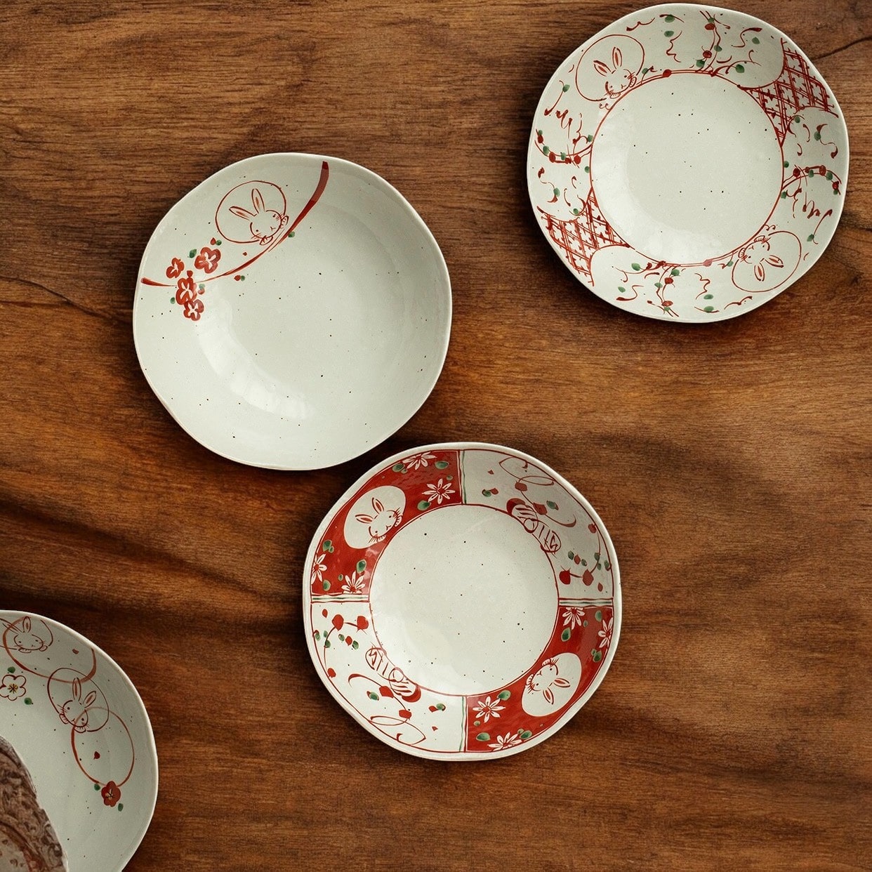 Hand holding a rabbit-themed ceramic dish with intricate design