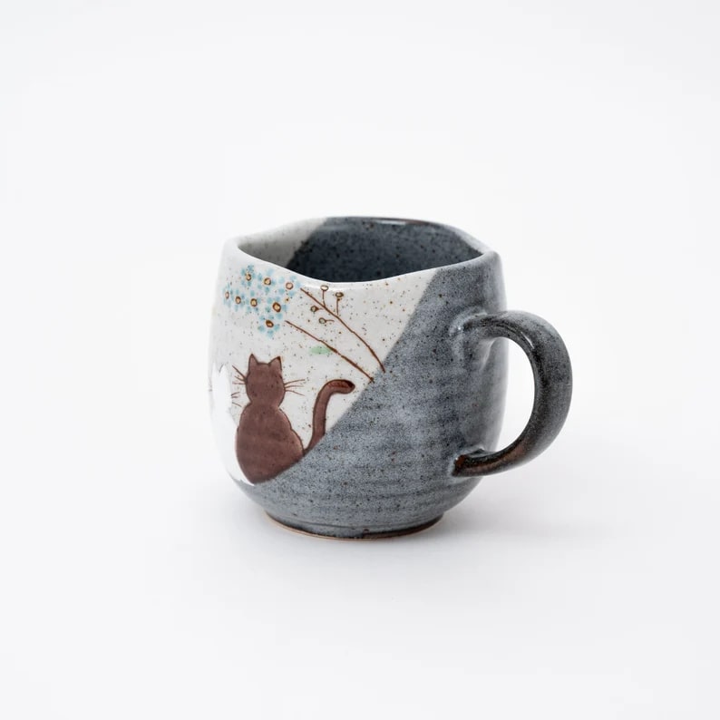 Japanese ceramic mug featuring a hand-painted brown cat design