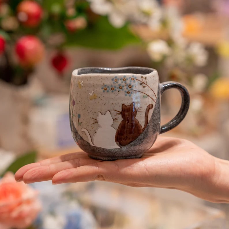 Artisan Kutani ware mug with ergonomic handle and floral accents