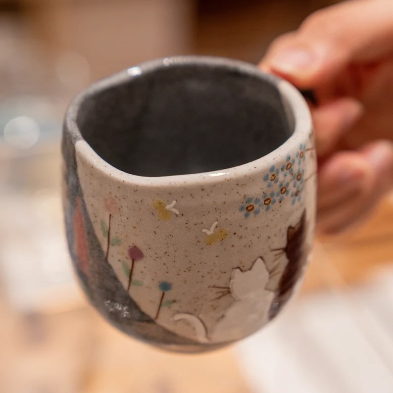 Japanese ceramic mug featuring a hand-painted brown cat design