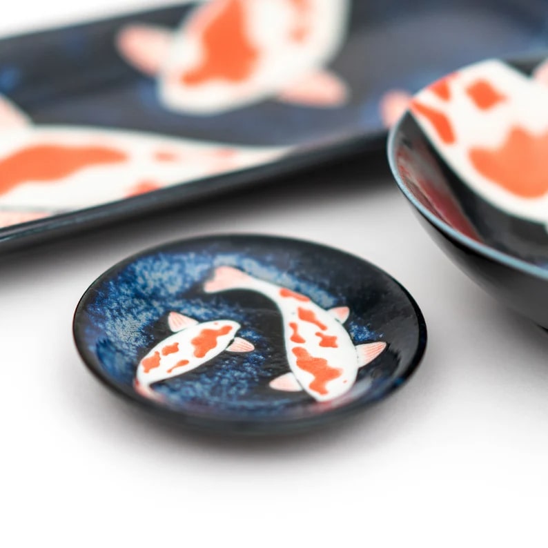 Japanese sushi plates with artistic koi fish motifs.
