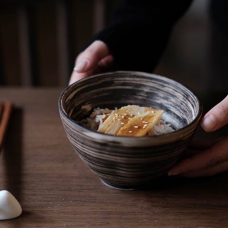 Rustic stoneware bowls stacked on a wooden table