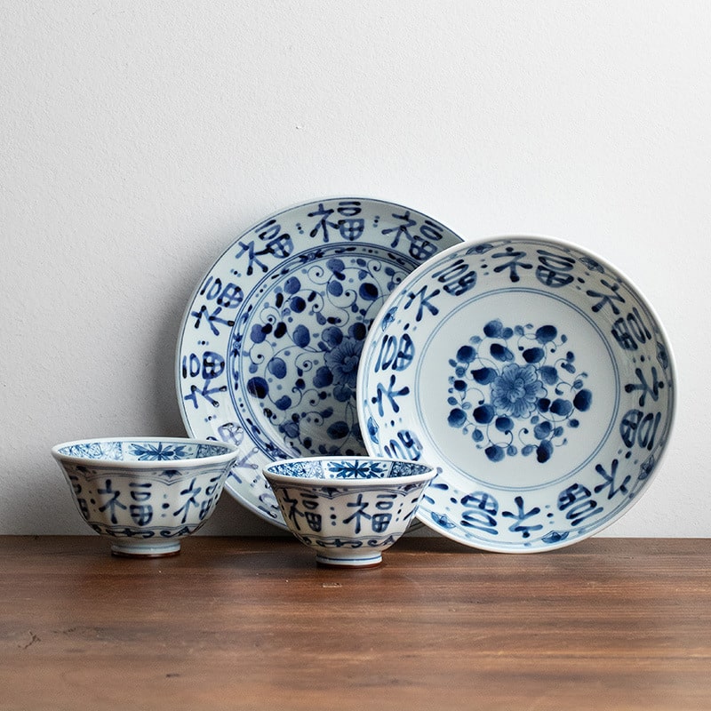 Blue and white porcelain plates with floral and calligraphy designs