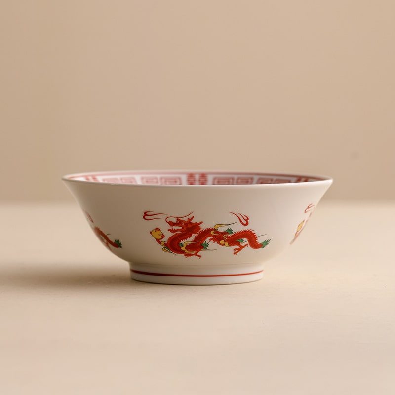 Traditional dragon and phoenix porcelain bowls side by side