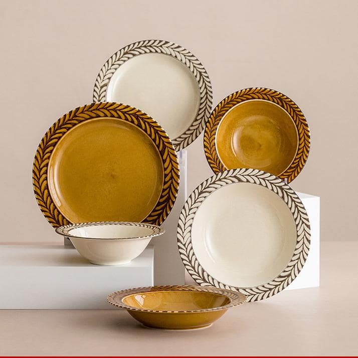 Elegant ceramic plate with leaf border design and dessert served