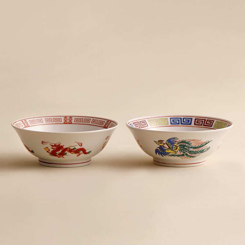 Asian-inspired ceramic bowl with intricate phoenix and border details