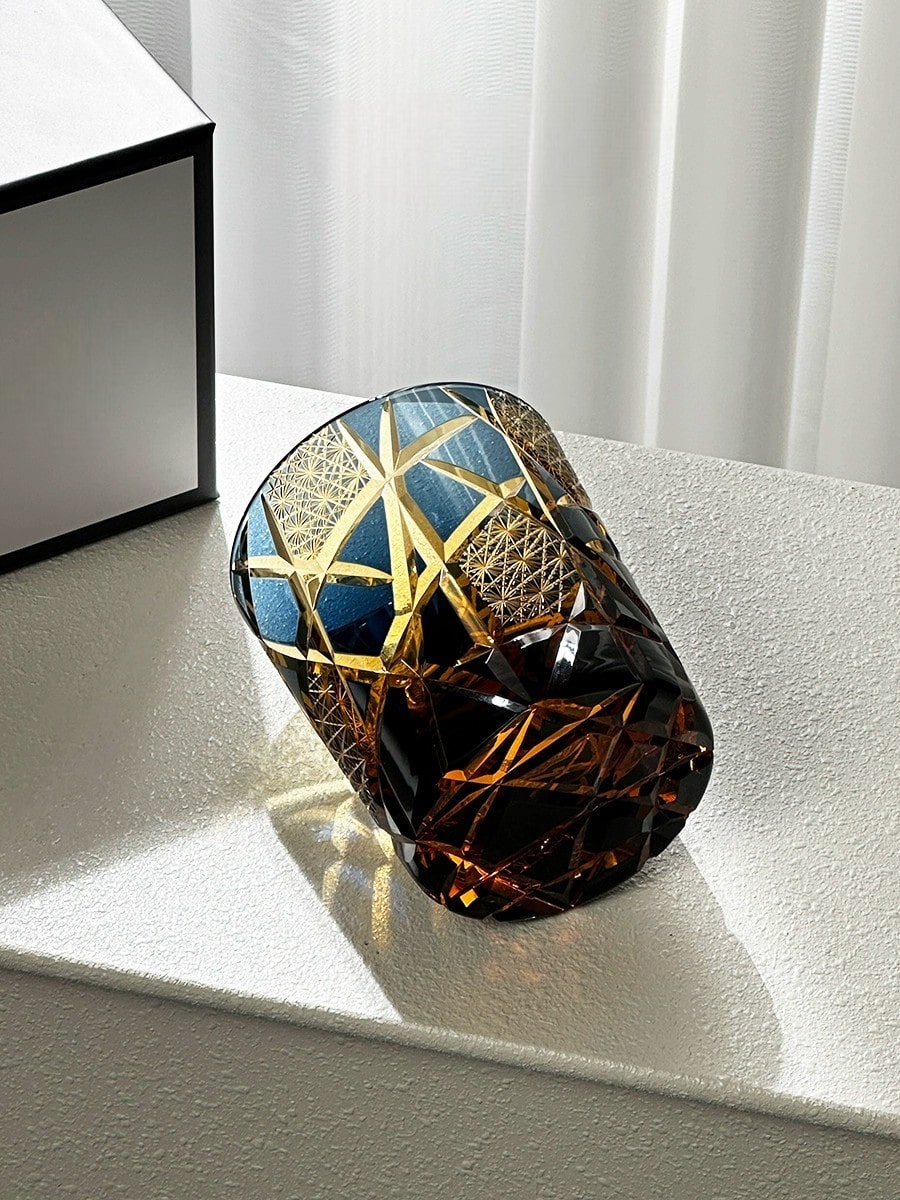 Hand-carved Edo Kiriko whiskey glass with amber and blue gradient design.
