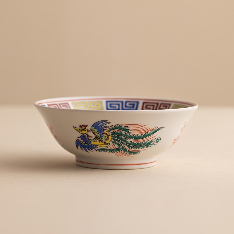 Close-up of a red dragon design on a porcelain bowl