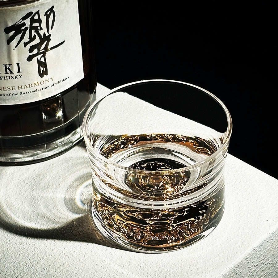 Close-up of handcrafted whiskey glass featuring a sleek design and detailed base.
