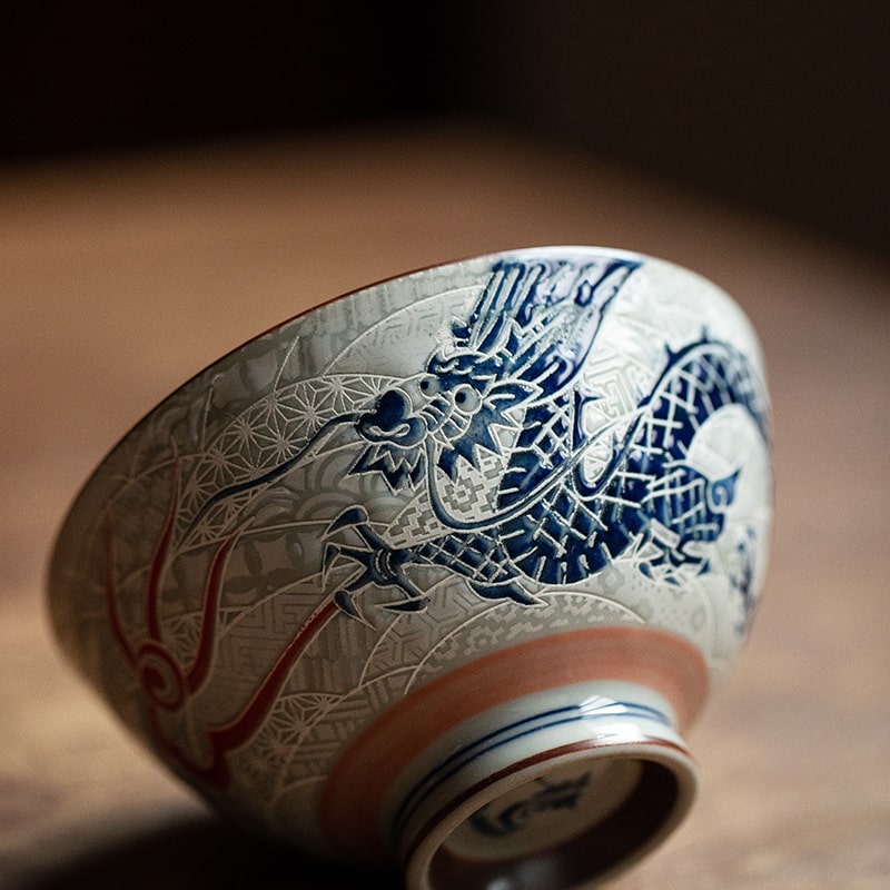 Close-up of embossed dragon motif on ceramic porcelain bowl