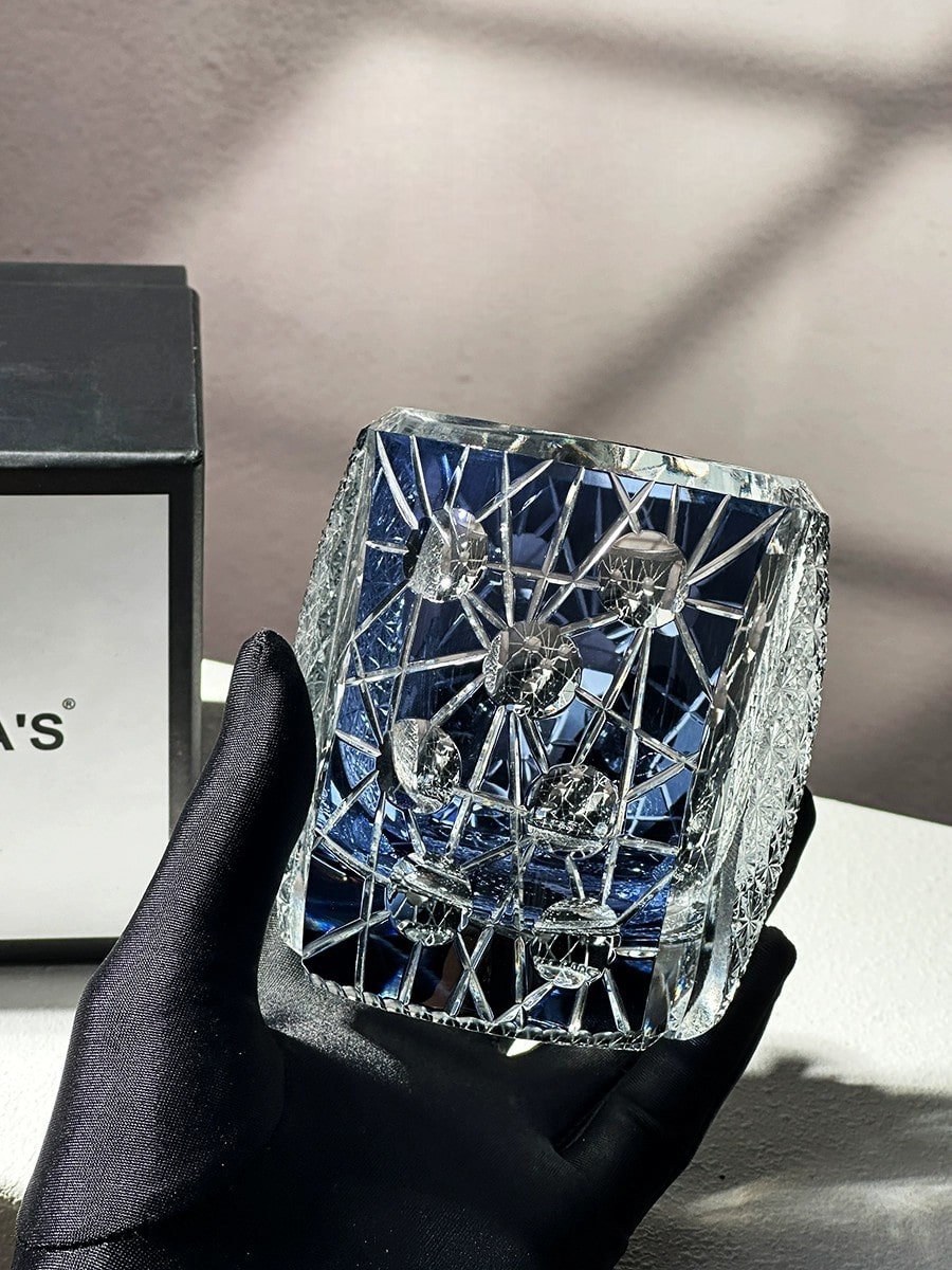 Unique blue and black crystal glass with intricate patterns, perfect for fine whiskey.
