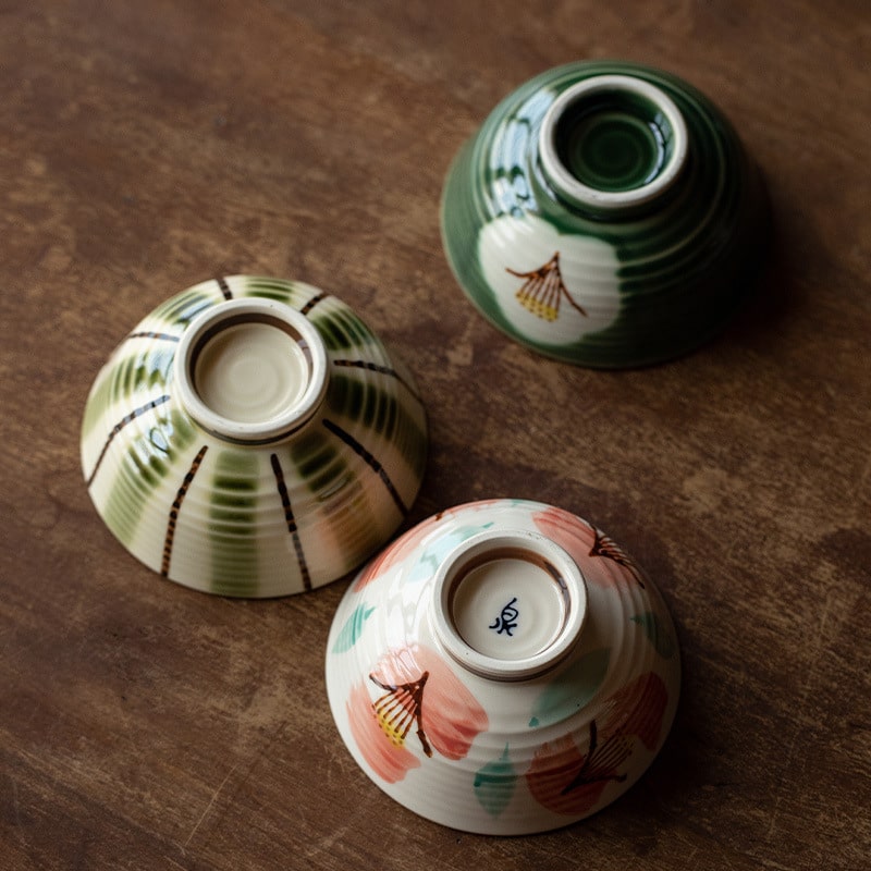 Handcrafted ceramic bowl with green and white floral design