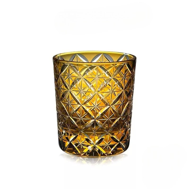 Amber hand-carved "Seven Treasures" crystal whiskey glass with intricate starburst design, perfect for whiskey lovers.