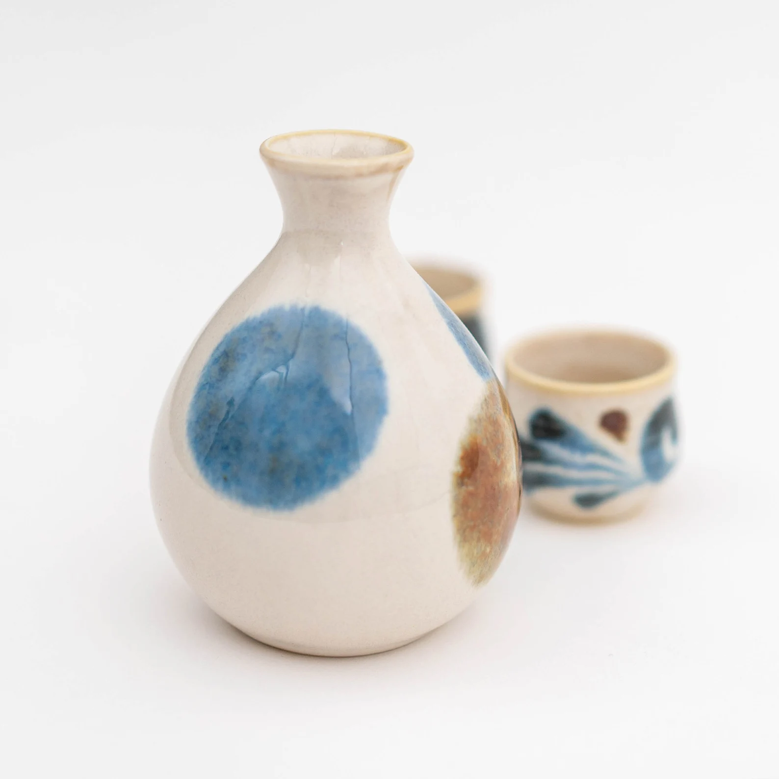 Artisanal sake drinking set featuring a smoothly glazed carafe