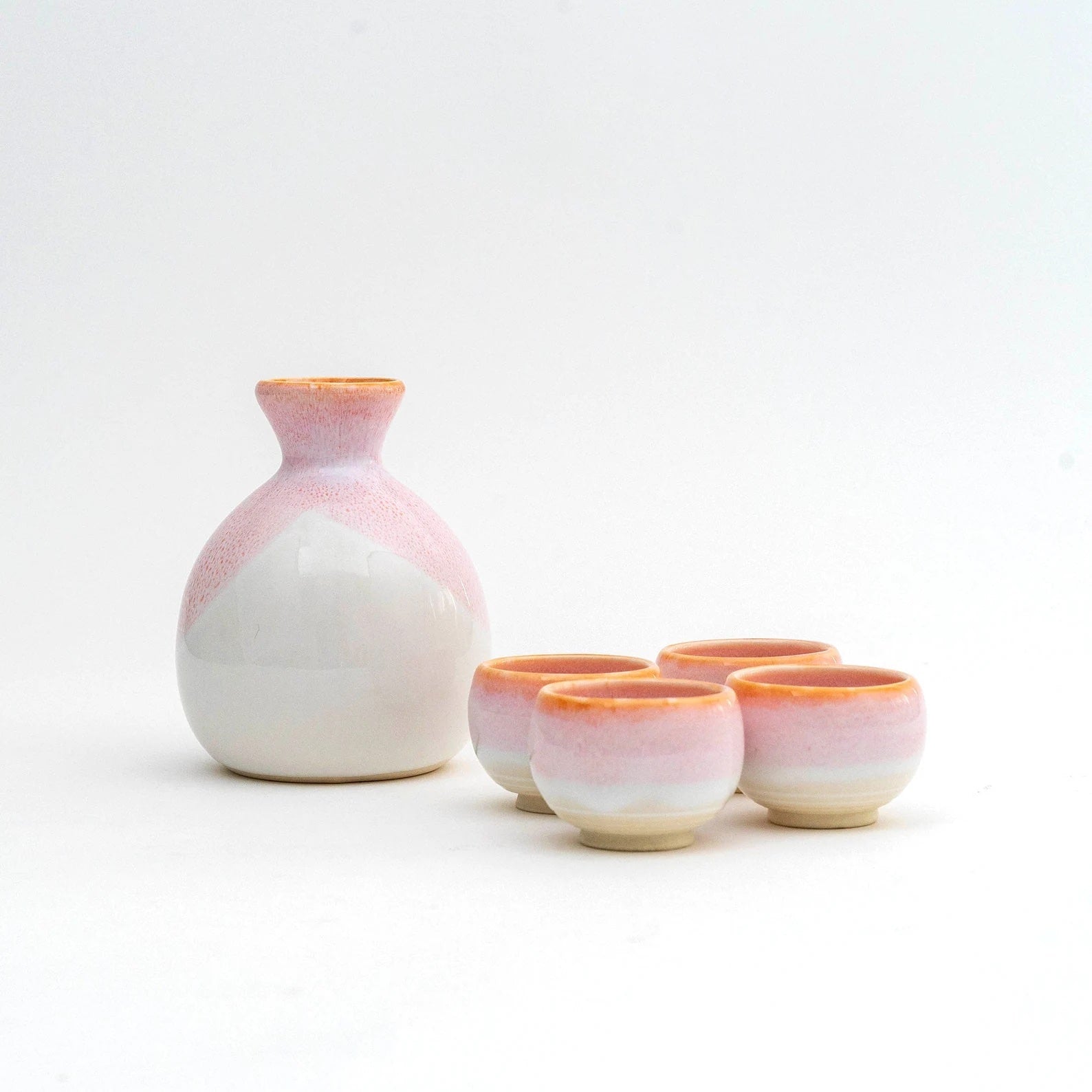 Close-up of a pink sake cup set showcasing smooth ceramic texture