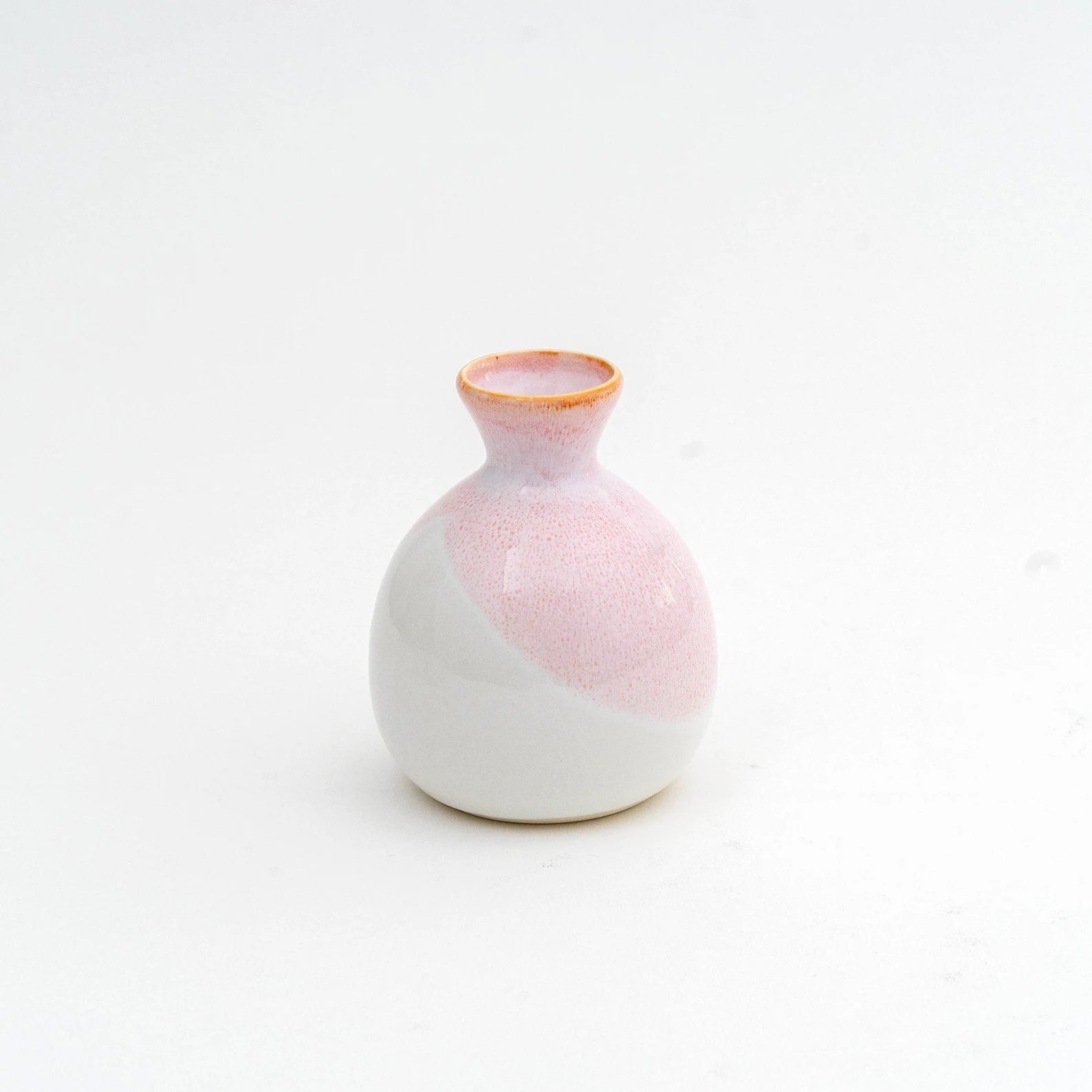 Close-up of a pink sake cup set showcasing smooth ceramic texture