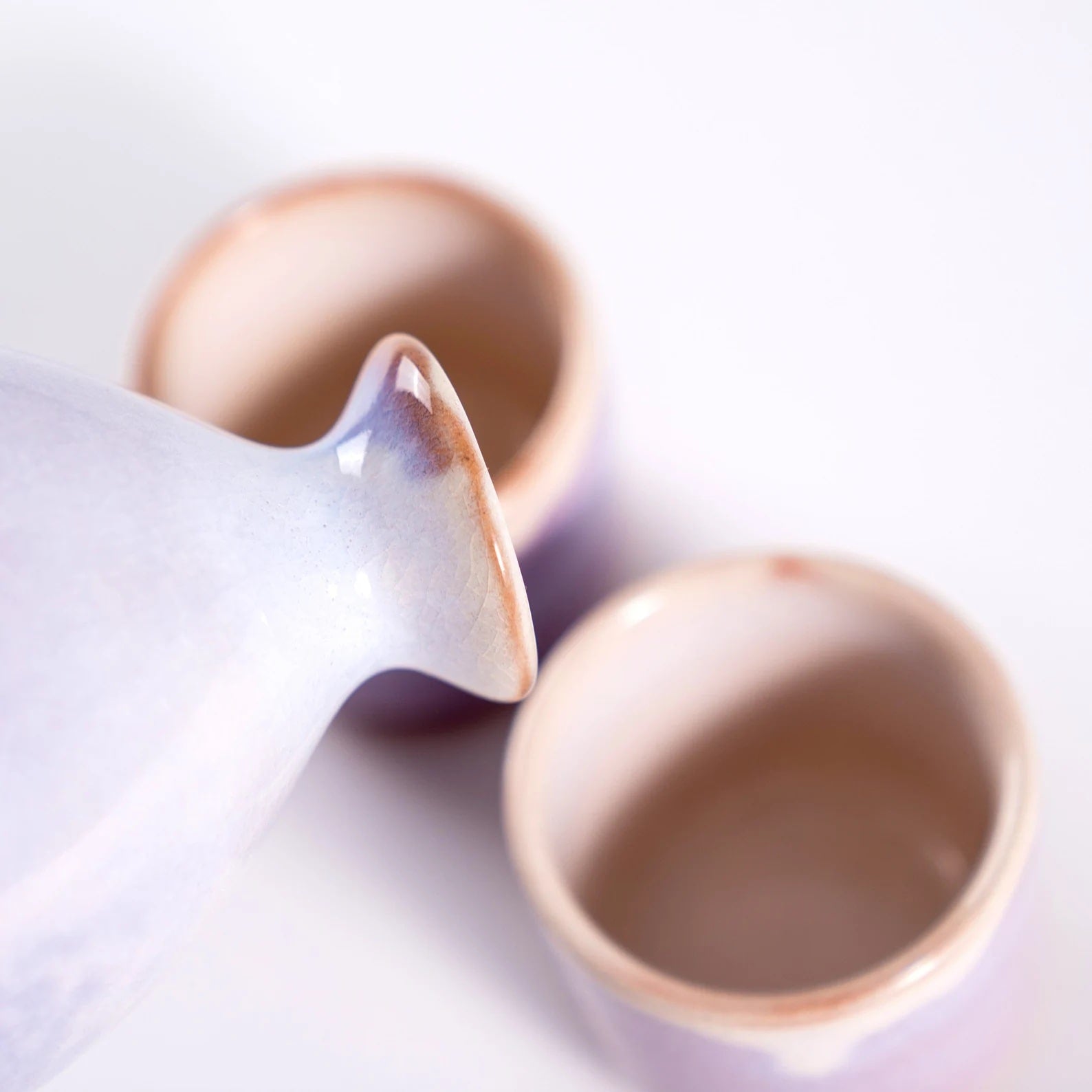 Handcrafted ceramic sake cup set showing delicate texture