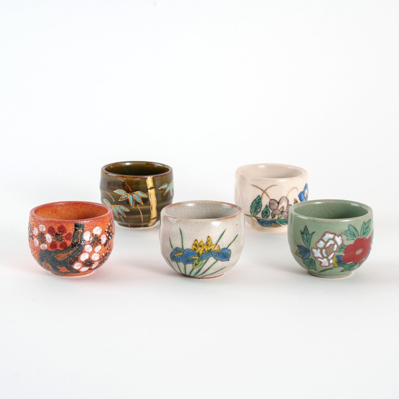 Hand-painted Japanese sake cup set featuring floral and nature motifs.
