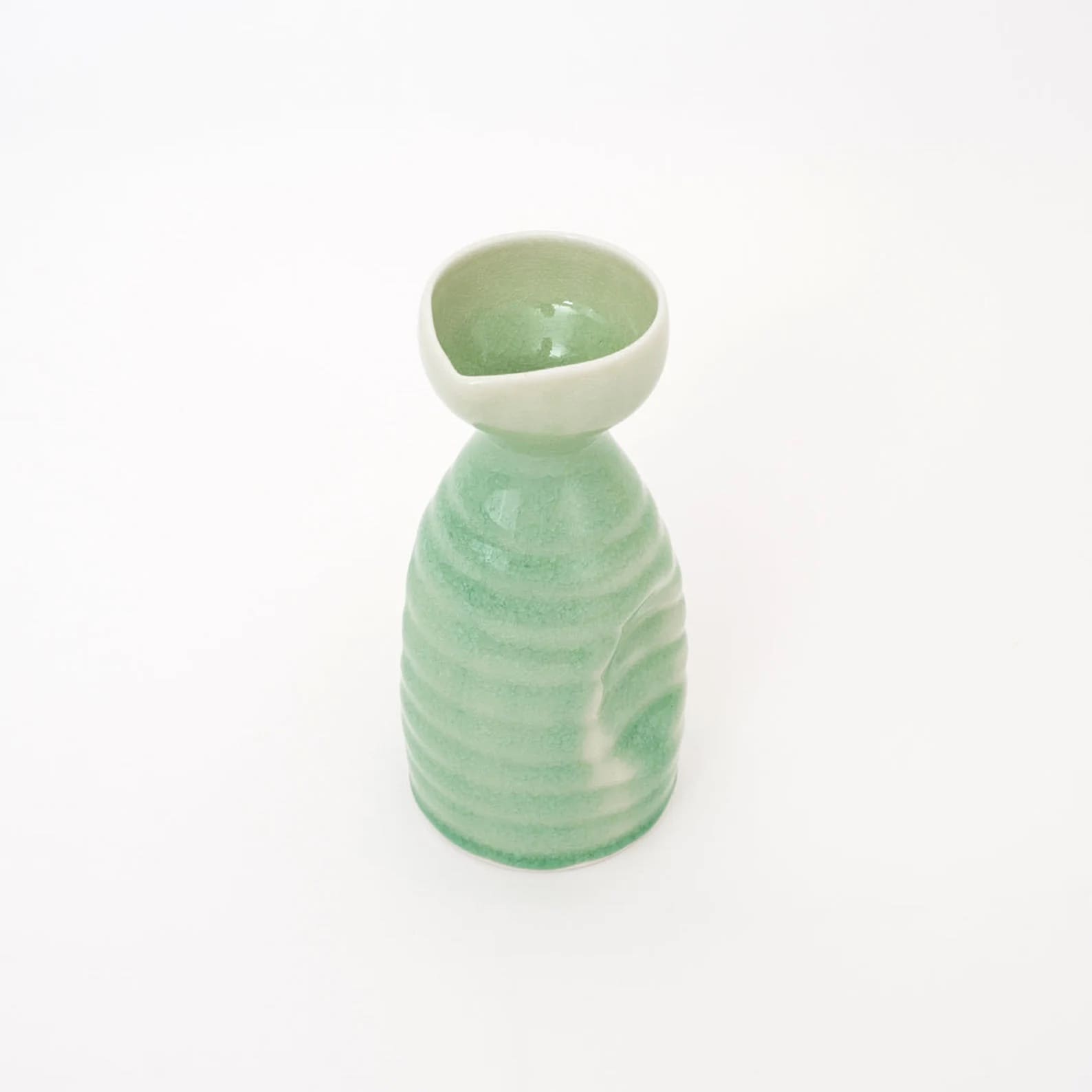 Artisanal ceramic set sake displayed on a smooth wooden surface