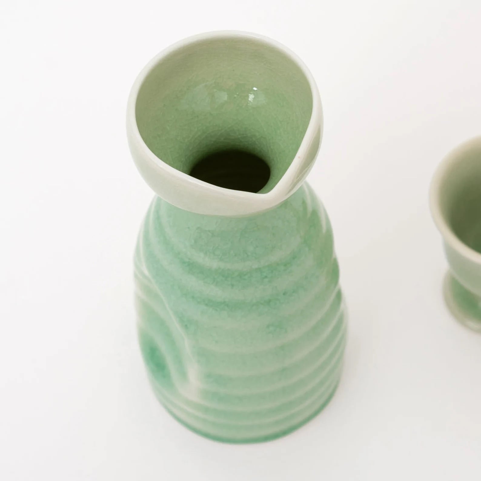 Artisanal ceramic set sake displayed on a smooth wooden surface