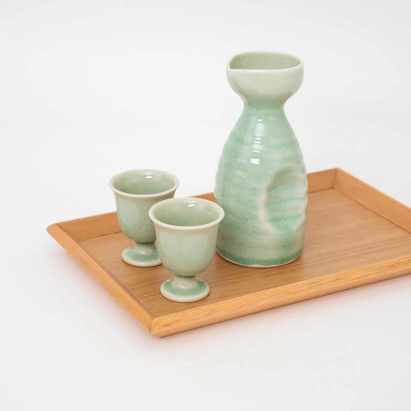 Artisanal ceramic set sake displayed on a smooth wooden surface