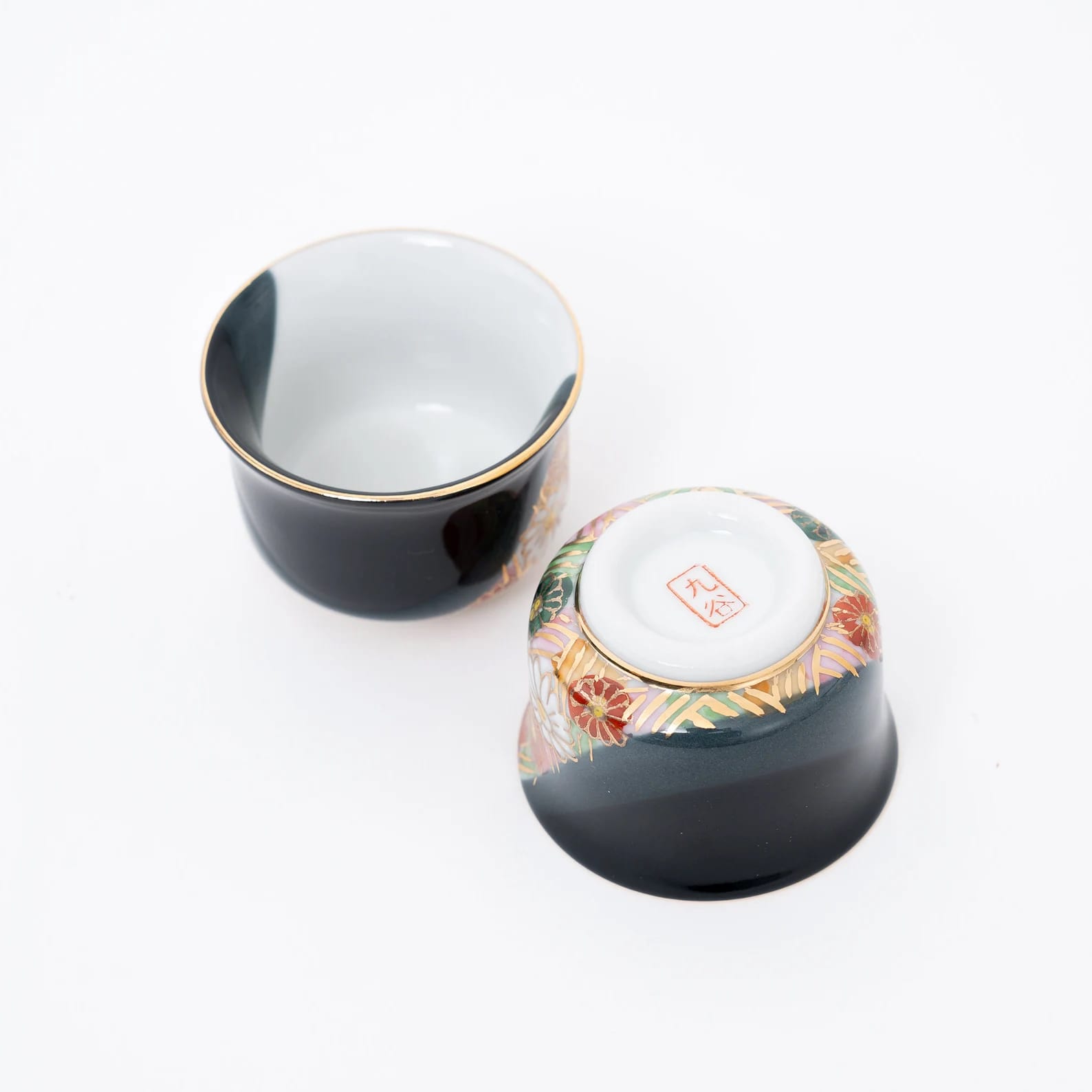 Vibrantly colored sake cup set featuring golden accents