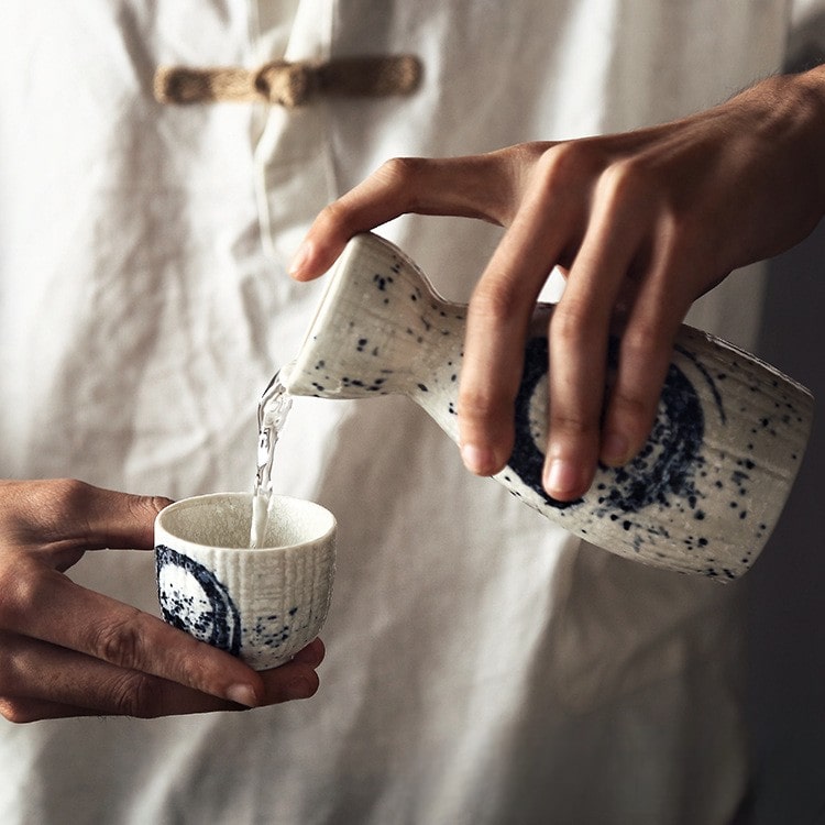 Close-up of sake drinking set highlighting textured ceramic details.
