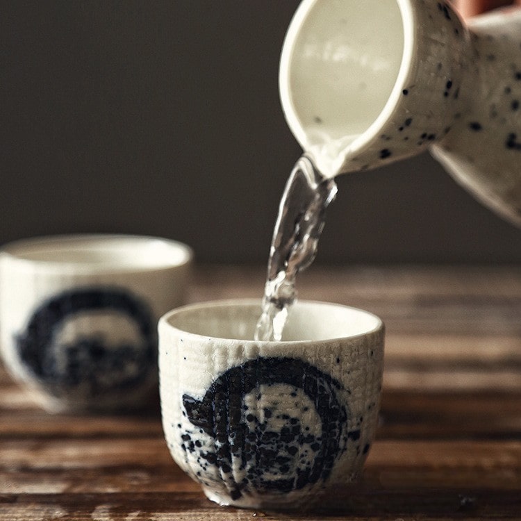 Close-up of sake drinking set highlighting textured ceramic details.
