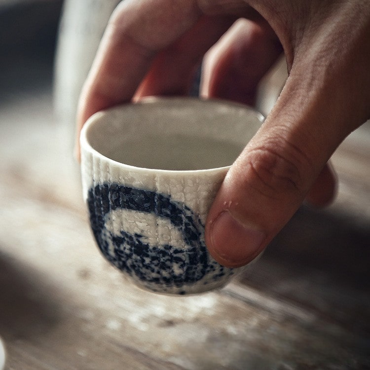 Elegant sake cup set with a speckled finish and modern brushstroke motifs.
