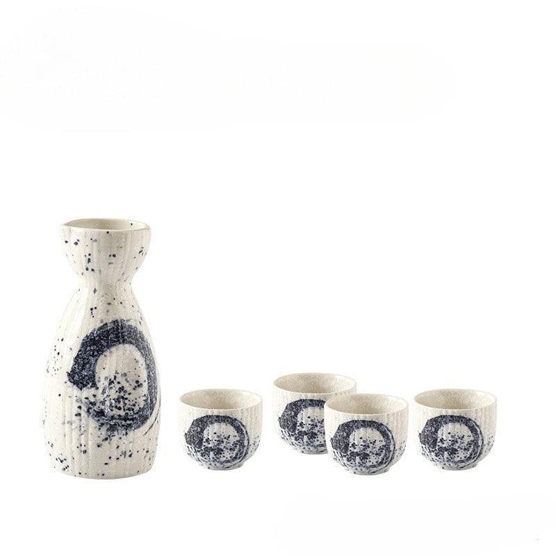 Minimalist sake set with bold black brushstroke patterns on speckled ceramic.
